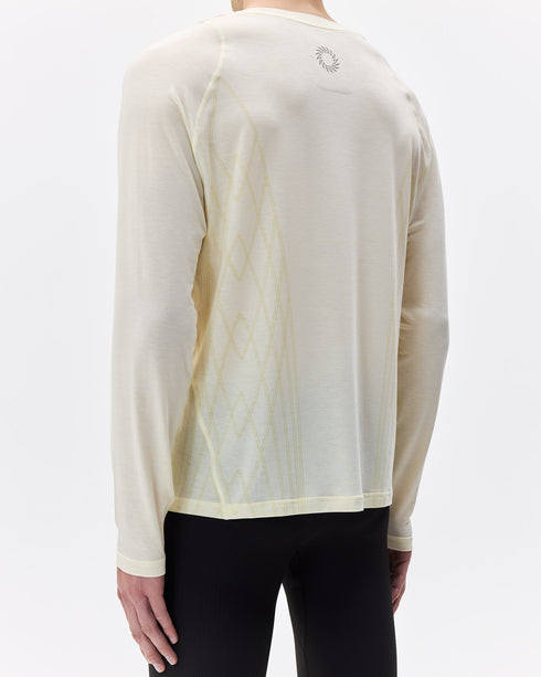 Person wearing a light-colored long-sleeve athletic shirt with a subtle pattern on a white background