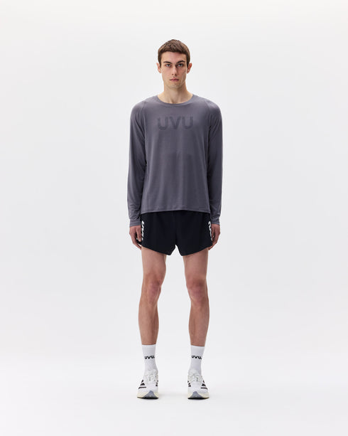 Person wearing a gray long-sleeve shirt and black shorts with 'UVU' branding on a white background