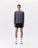 Person wearing a gray long-sleeve shirt and black shorts with 'UVU' branding on a white background