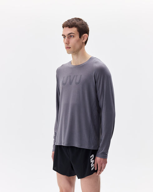 Person wearing a gray long-sleeve shirt and black shorts with 'UVA' branding on a white background
